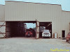 Trucks in north bay being loaded by overhead cranes