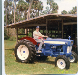 Frank Overstreet sitting on freshly rebuilt Ford 4000 tractor at family farm.