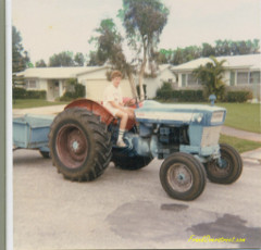 Frank Overstreet's younger brother sitting on Ford 4000 our dad just bought. Frank Overstreet's younger brother on Ford 4000 tractor.